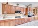 Kitchen with a tiled backsplash, plenty of wood cabinets, and modern appliances at 471 Eagle Vista Dr, Henderson, NV 89012