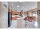 Well-lit kitchen with wood cabinets, breakfast bar, and dining area at 471 Eagle Vista Dr, Henderson, NV 89012