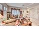 Cozy living room featuring plantation shutters, comfortable seating, and warm, inviting decor at 471 Eagle Vista Dr, Henderson, NV 89012