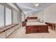 Spacious main bedroom features a large bed, mirrored wall, and window seat with plantation shutters at 471 Eagle Vista Dr, Henderson, NV 89012