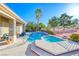 Sparkling backyard pool and spa surrounded by lush landscaping and patio space at 471 Eagle Vista Dr, Henderson, NV 89012