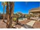 Landscaped backyard with a refreshing pool and ample lounging space under a covered patio at 5635 Exotic Rosette Ave, Las Vegas, NV 89139