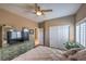 Well-lit bedroom with a ceiling fan, closet, and TV atop the dresser at 5635 Exotic Rosette Ave, Las Vegas, NV 89139