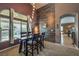 Dining area with a wood table and modern light fixture at 5635 Exotic Rosette Ave, Las Vegas, NV 89139