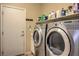 Functional laundry room equipped with modern washer and dryer units and storage at 5635 Exotic Rosette Ave, Las Vegas, NV 89139