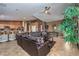 Open concept living room with a leather sectional sofa and view into kitchen at 5635 Exotic Rosette Ave, Las Vegas, NV 89139