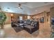 Living room with open layout, leather sectional and kitchen view at 5635 Exotic Rosette Ave, Las Vegas, NV 89139