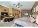 Spacious main bedroom with neutral tones, including seating area and large television for relaxing at 5635 Exotic Rosette Ave, Las Vegas, NV 89139