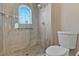 Bathroom features a glass walk-in shower with stone accents and a water-saving toilet at 5734 San Florentine Ave, Las Vegas, NV 89141