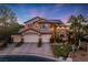 Beautiful two-story home with a three-car garage, desert landscaping, and solar panels at 5734 San Florentine Ave, Las Vegas, NV 89141