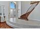 Grand foyer with soaring ceilings, tiled landing, staircase, and light fixture create an inviting entrance at 5734 San Florentine Ave, Las Vegas, NV 89141