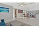 Upstairs hallway with gray walls, a soft rug, wood railings, and picturesque beach and city art at 5734 San Florentine Ave, Las Vegas, NV 89141