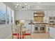 Open-concept kitchen and dining area with stainless steel appliances and stylish light fixture at 5734 San Florentine Ave, Las Vegas, NV 89141