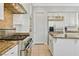 Bright kitchen showcasing stainless steel appliances, granite counters, and white cabinets at 5734 San Florentine Ave, Las Vegas, NV 89141