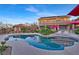 Inviting backyard oasis featuring a freeform pool, sun umbrellas, patio seating, and a two-story home at 5734 San Florentine Ave, Las Vegas, NV 89141