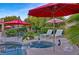 Relaxing outdoor spa featuring sun umbrellas, lounge chairs, and a lush tropical landscape at 5734 San Florentine Ave, Las Vegas, NV 89141