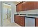 Cherry wood wet bar featuring granite countertops, stainless steel under counter refrigerator, and storage at 5734 San Florentine Ave, Las Vegas, NV 89141