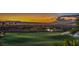 Aerial view of golf course with city skyline at sunset at 583 Saint Croix St, Henderson, NV 89012