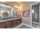 Bathroom with double vanity, large mirror, and walk-in shower at 583 Saint Croix St, Henderson, NV 89012