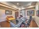 Modern home office with a large desk, comfortable seating, and hardwood floors at 583 Saint Croix St, Henderson, NV 89012