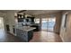 Kitchen with dark cabinets, quartz countertops and sliding door to backyard at 612 Essex East Dr, Las Vegas, NV 89107