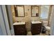 Bathroom with dual vanities, mirrors, and an enclosed toilet at 6296 Peach Orchard Rd, Las Vegas, NV 89142