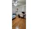 Bedroom with laminate wood floors, a ceiling fan, and bright window at 6296 Peach Orchard Rd, Las Vegas, NV 89142