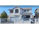 Beautiful two-story home featuring white stucco, trimmed windows and doors, a gated yard and a two car garage at 6296 Peach Orchard Rd, Las Vegas, NV 89142