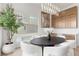 Bright dining area with round table and chairs, modern light fixture, and large windows at 671 Sentinel Spire St, Las Vegas, NV 89138