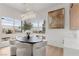 Modern dining area with a round table, four chairs, and large windows at 671 Sentinel Spire St, Las Vegas, NV 89138