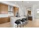 Modern kitchen with stainless steel appliances and light wood cabinets at 671 Sentinel Spire St, Las Vegas, NV 89138