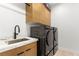 Laundry room featuring modern washer, dryer, and cabinetry at 671 Sentinel Spire St, Las Vegas, NV 89138