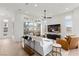 Bright living room with hardwood floors, modern furniture, and a large TV at 671 Sentinel Spire St, Las Vegas, NV 89138