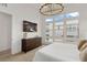 Main bedroom with large windows, dresser, and TV at 671 Sentinel Spire St, Las Vegas, NV 89138