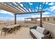 Relaxing rooftop deck with pergola, seating, and dining area at 671 Sentinel Spire St, Las Vegas, NV 89138