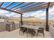 Outdoor kitchen and dining area on rooftop deck at 671 Sentinel Spire St, Las Vegas, NV 89138