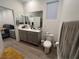 Main bathroom with double vanity and view of bedroom at 6842 Laguna Blanca St, North Las Vegas, NV 89086