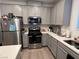 Modern kitchen with stainless steel appliances and gray cabinets at 6842 Laguna Blanca St, North Las Vegas, NV 89086