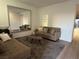 Living room with light brown couch and large mirror at 6842 Laguna Blanca St, North Las Vegas, NV 89086