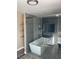 Luxurious bathroom with modern tub, frameless shower doors and stylish tile work at 7237 William Anders Ave, Las Vegas, NV 89145