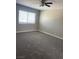 Bright bedroom features a ceiling fan, neutral walls, new carpet and a window with horizontal blinds at 7237 William Anders Ave, Las Vegas, NV 89145