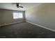 Bright bedroom features a ceiling fan, neutral walls, new carpet and a window with horizontal blinds at 7237 William Anders Ave, Las Vegas, NV 89145