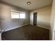 Neutral bedroom featuring a window and closet with carpet at 7237 William Anders Ave, Las Vegas, NV 89145