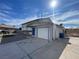 Two-story home with neutral siding, front garage, driveway and desert landscaping for low maintenance at 7237 William Anders Ave, Las Vegas, NV 89145