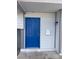 Close-up of a bright blue front door with white trim and a modern mailbox at 7237 William Anders Ave, Las Vegas, NV 89145