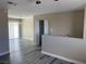 Open living area featuring modern flooring, neutral wall colors, a closet, and access to a balcony at 7237 William Anders Ave, Las Vegas, NV 89145