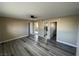 Open concept living room with new vinyl plank flooring, neutral paint and new fixtures at 7237 William Anders Ave, Las Vegas, NV 89145