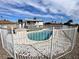 Backyard with a fenced kidney-shaped pool with white brick coping and house view at 7237 William Anders Ave, Las Vegas, NV 89145