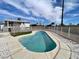 Backyard with a fenced kidney-shaped pool with white brick coping and house view at 7237 William Anders Ave, Las Vegas, NV 89145