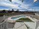 Backyard with a fenced kidney-shaped pool and artificial turf seen from the upper deck at 7237 William Anders Ave, Las Vegas, NV 89145